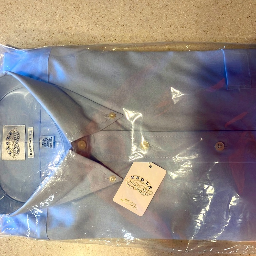 Brand new Eagle button down dress shirts.  Blue, long sleeve.